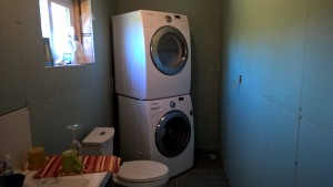 Washer and dryer stacked in place